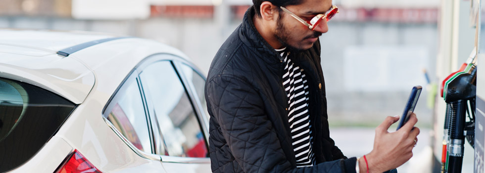 petroleum customer filling up at the pump with loyalty app